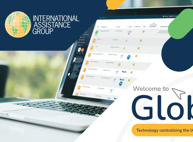 A laptop displaying a dashboard is shown with the International Assistance Group logo on the top left and the words "Welcome to Glob" and "Technology centralising the IA" on the right.